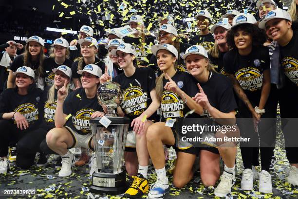 The Iowa Hawkeyes celebrate defeating the Nebraska Cornhuskers 94-89 in overtime to win the Big Ten Women's Basketball Tournament Championship at...