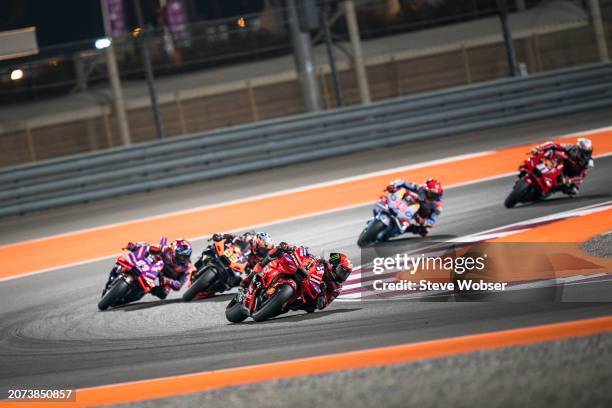 Francesco Bagnaia of Italy and Ducati Lenovo Team leads the race in front of Brad Binder of South Africa and Red Bull KTM Factory Racing and Jorge...