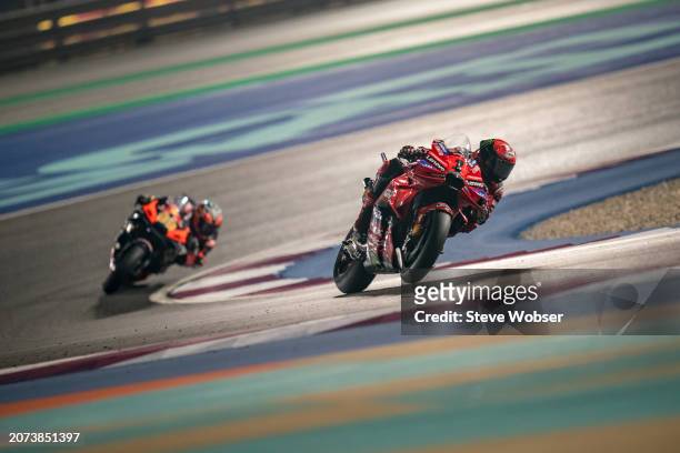 Francesco Bagnaia of Italy and Ducati Lenovo Team leads in front of Brad Binder of South Africa and Red Bull KTM Factory Racing during the Race of...