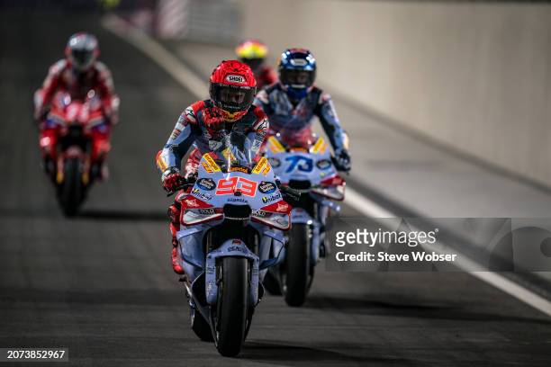 Marc Marquez of Spain and Gresini Racing MotoGP rolls into the pitlane next to his brother M73L during the Race of the MotoGP Qatar Airways Grand...
