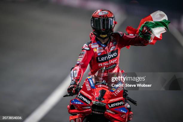 Francesco Bagnaia of Italy and Ducati Lenovo Team enters parc ferme with the italian flag after he won the race during the Race of the MotoGP Qatar...