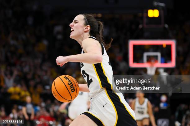 Caitlin Clark of the Iowa Hawkeyes celebrates defeating the Nebraska Cornhuskers 94-89 in overtime to win the Big Ten Women's Basketball Tournament...