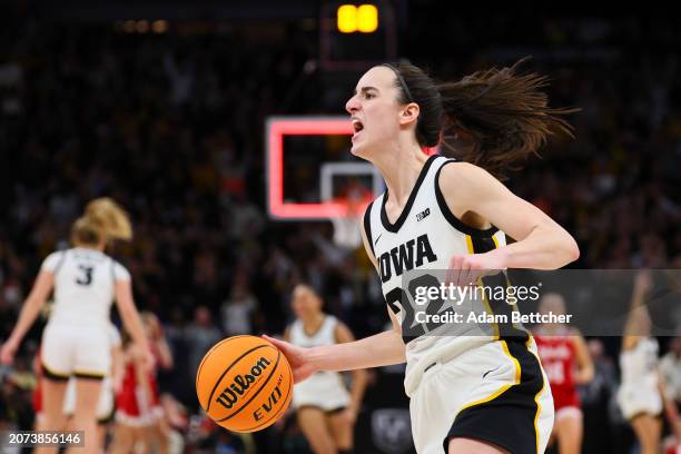 Caitlin Clark of the Iowa Hawkeyes celebrates defeating the Nebraska Cornhuskers 94-89 in overtime to win the Big Ten Women's Basketball Tournament...