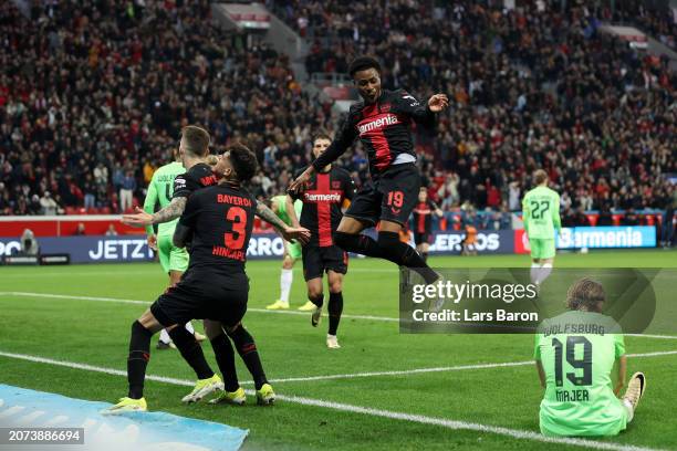 Nathan Tella of Bayer Leverkusen celebrates with teammates after scoring his team's first goal during the Bundesliga match between Bayer 04...