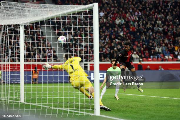 Nathan Tella of Bayer Leverkusen scores his team's first goal past Koen Casteels of VfL Wolfsburg during the Bundesliga match between Bayer 04...