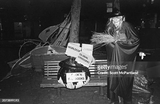 View of a costumed person, dressed as a witch and carrying a broom, during the 29th annual Village Halloween Parade, on 6th Avenue , New York, New...