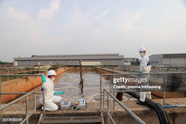 biologists and wastewater treatment experts conduct water quality simulation experiments. at the wastewater treatment plant - biologist stock pictures, royalty-free photos & images