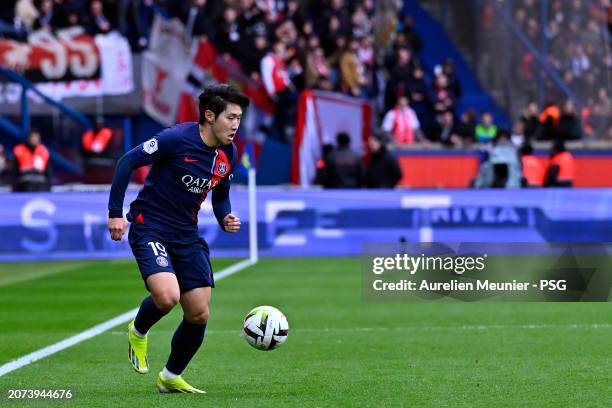 Lee Kang In of Paris Saint-Germain runs with the ball during the Ligue 1 Uber Eats match between Paris Saint-Germain and Stade de Reims at Parc des...