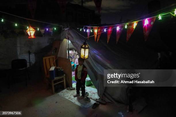 Rafah, Gaza Displaced Palestinians decorate their tent in preparation for the holy month of Ramadan on March 10, 2024 in Rafah, Gaza. The United...