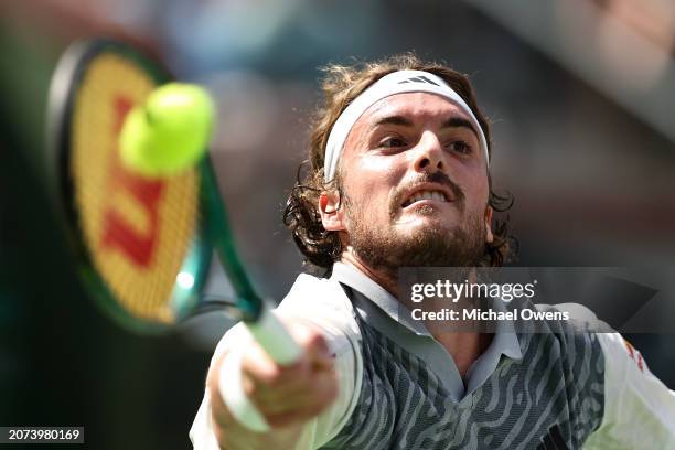 Stefanos Tsitsipas of Greece returns a shot against Frances Tiafoe of the United States during the BNP Paribas Open at Indian Wells Tennis Garden on...