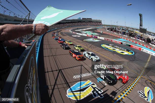 Denny Hamlin, driver of the Mavis Brakes Plus Toyota, leads the field to the green flag to start the NASCAR Cup Series Shriners Children's 500 at...