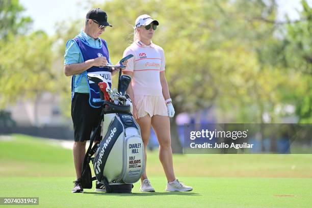 Charley Hull of England looks on from the first hole with caddie Adam Woodward during day three of the Aramco Team Series, Tampa at Feather Sound...