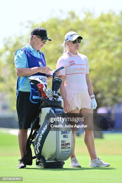 Charley Hull of England looks on from the first hole with caddie Adam Woodward during day three of the Aramco Team Series, Tampa at Feather Sound...