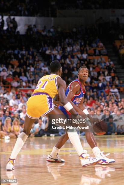 Isiah Thomas of the Detroit Pistons drives against Michael Cooper of the Los Angeles Lakers during a game at the Great Western Forum in Los Angeles,...