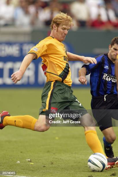 Defender Alexi Lalas of the Los Angeles Galaxy kicks the ball against the Colorado Rapids in the inaugural match at the state-of-the-art Home Depot...