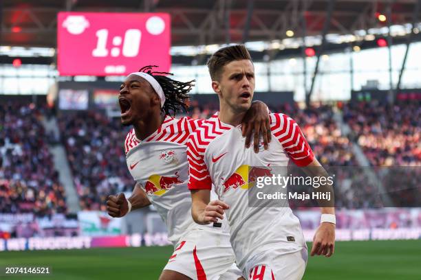 Christoph Baumgartner of RB Leipzig celebrates scoring his team's second goal with teammate Mohamed Simakan during the Bundesliga match between RB...