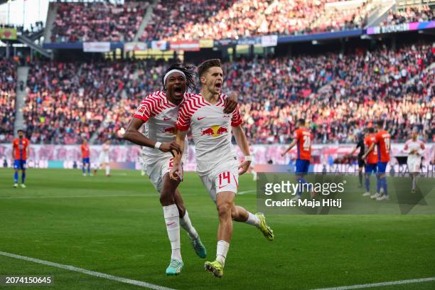 Christoph Baumgartner of RB Leipzig celebrates scoring his team's second goal with teammate Mohamed Simakan during the Bundesliga match between RB...