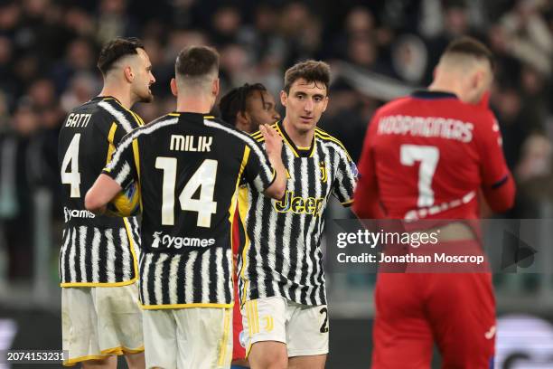 Teun Koopmeiners of Atalanta reacts as Andrea Cambiaso of Juventus celebrates with team mates Federico Gatti and Arkadiusz Milik after scoring to...