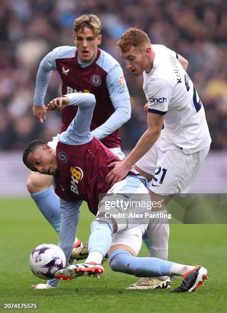 Ezri Konsa of Aston Villa is tackled by Dejan Kulusevski of Tottenham Hotspur during the Premier League match between Aston Villa and Tottenham...