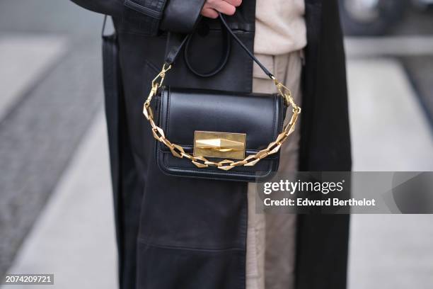 Natalia Verza wears a black leather with golden detail bag by Jimmy choo, during a street style fashion photo session, on March 09, 2024 in Paris,...