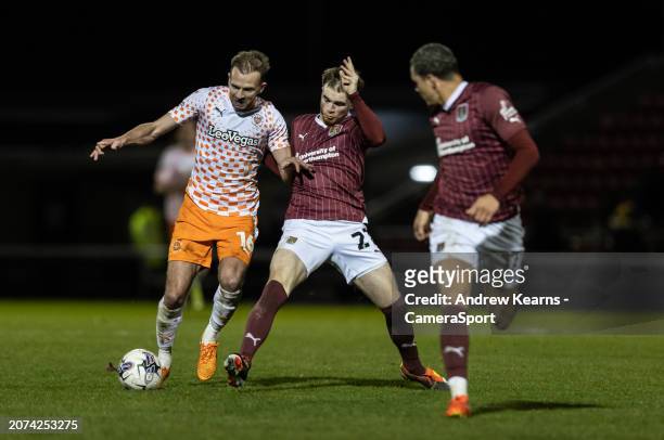 Blackpool's Jordan Rhodes competing with Northampton Town's Marc Leonard during the Sky Bet League One match between Northampton Town and Blackpool...