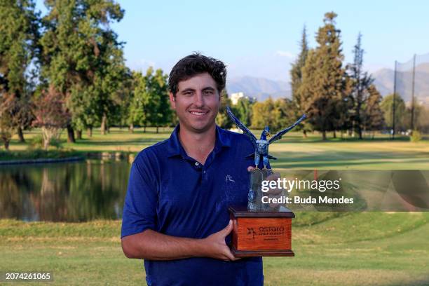 Taylor Dickson of the United States celebrates with the winner's trophy after winning on the 18th hole during the final round of the Astara Chile...