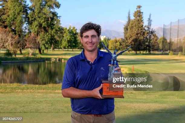 Taylor Dickson of the United States celebrates with the winner's trophy after winning on the 18th hole during the final round of the Astara Chile...