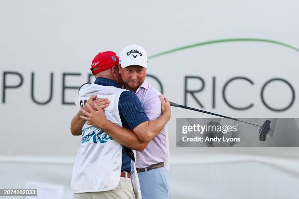 Brice Garnett of the United States celebrates with caddie Chris Callas after making his putt for birdie on the 18th green, the fourth-playoff hole,...