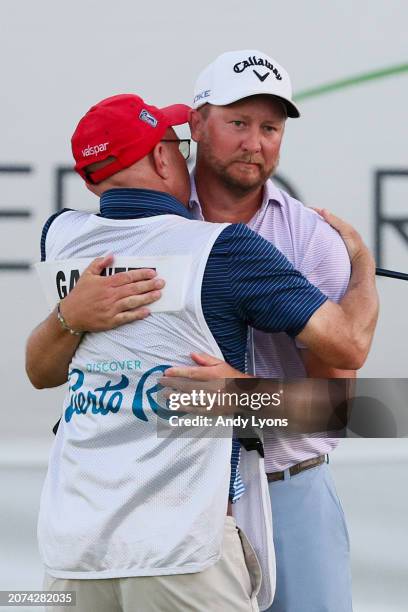 Brice Garnett of the United States celebrates with caddie Chris Callas after making his putt for birdie on the 18th green, the fourth-playoff hole,...