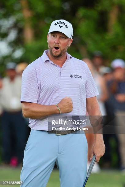 Brice Garnett of the United States celebrates making his putt for birdie on the 18th green, the fourth-playoff hole, to win against Erik Barnes of...