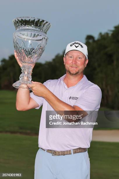 Brice Garnett of the United States celebrates with the trophy after his win during a four-hole playoff against Erik Barnes of the United States...