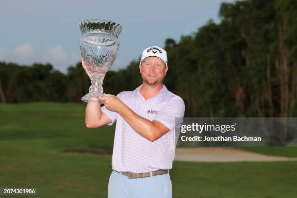 Brice Garnett of the United States celebrates with the trophy after his win during a four-hole playoff against Erik Barnes of the United States...