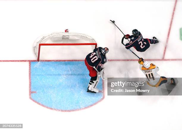 Adam Boqvist of the Columbus Blue Jackets skates with the puck while Gustav Nyquist of the Nashville Predators defends during the third period at...