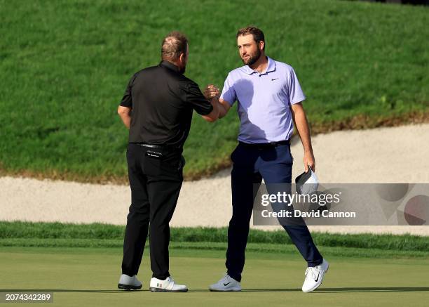 Scottie Scheffler of The United States is congratulated by his playing partner Shane Lowry of Ireland on the 18th hole during the final round of the...