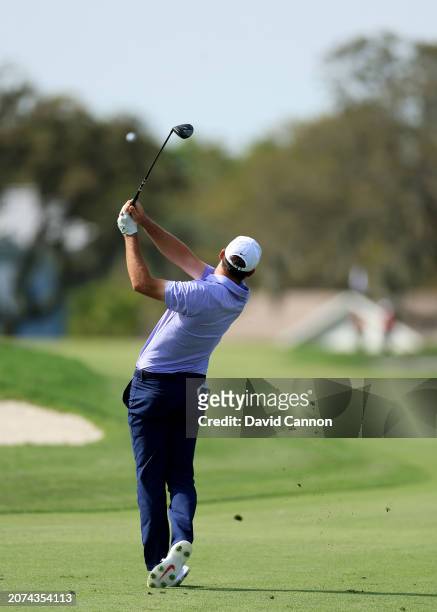 This image is part of a sequence; Scottie Scheffler of The United States plays a 3-wood second shot on the par five 12th hole during the final round...