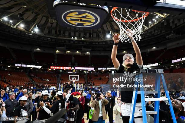 Te-Hina Paopao of the South Carolina Gamecocks cuts down part of the net after their win over the LSU Lady Tigers following the championship game of...