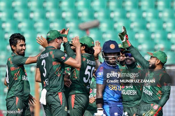 Bangladesh's Tanzim Hasan Sakib celebrates with teammates after taking the wicket of Sri Lanka's Pathum Nissanka during the first one-day...