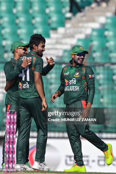 Bangladesh's Tanzim Hasan Sakib celebrates with teammates after taking the wicket of Sri Lanka's Pathum Nissanka during the first one-day...