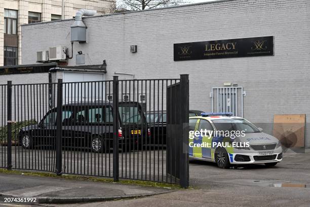 Police car is parked near a hearse outside a branch of Legacy Independent Funeral Directors in Hull, northeast England, on March 13, 2024. The bodies...