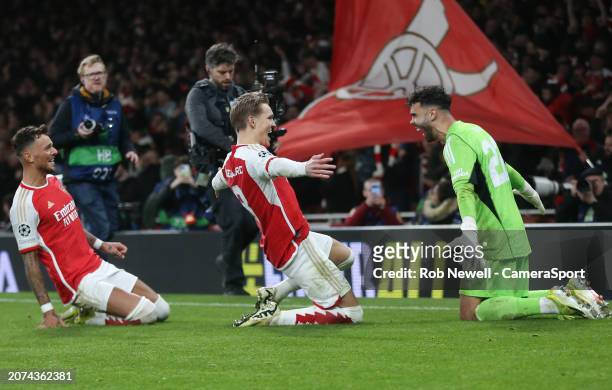 Arsenal's David Raya, Martin Odegaard and Ben White celebrate after winning the penalty shoot-out during the UEFA Champions League 2023/24 round of...