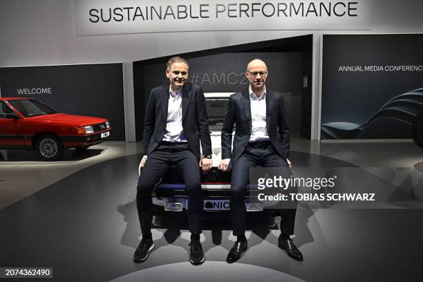 Oliver Blume , CEO of German carmaker Volkswagen , and the company's CFO Arno Antlitz pose on a Golf 1 GTI after a press conference to present the...