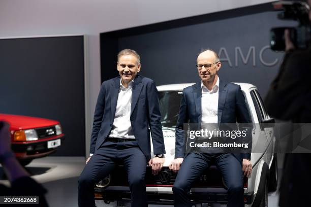 Oliver Blume, chief executive officer of Volkswagen AG, left, and Arno Antlitz, chief financial officer of Volkswagen AG, on the hood of a classic...