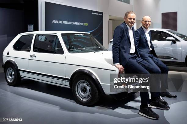 Oliver Blume, chief executive officer of Volkswagen AG, left, and Arno Antlitz, chief financial officer of Volkswagen AG, on the hood of a classic...