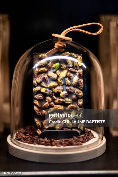 This photograph taken on March 13 in Paris, shows a chocolate bar displayed at one of French three Michelin stars chef Alain Ducasse's chocolate...