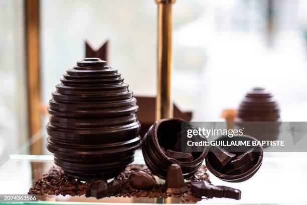 This photograph taken on March 13 in Paris, shows chocolate eggs displayed at one of French three Michelin stars chef Alain Ducasse's chocolate shop,...