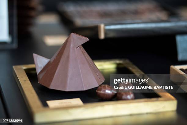 This photograph taken on March 13 in Paris, shows a chocolate hen displayed at one of French three Michelin stars chef Alain Ducasse's chocolate...