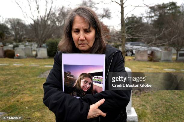 Deb Schmill holds a photograph of her daughter, Becca, during a visit to the Newton Cemetery where Becca is buried. She died in 2020 at the age of 18...