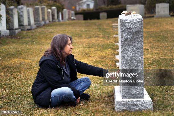 Deb Schmill places her hand on her daughter, Becca's, gravestone during a visit at the Newton Cemetery. She died in 2020 at the age of 18 and Deb...