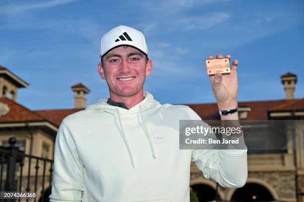 Nick Dunlap poses with. His PGA TOUr card during the first timers press conference prior to THE PLAYERS Championship at Stadium Course at TPC...
