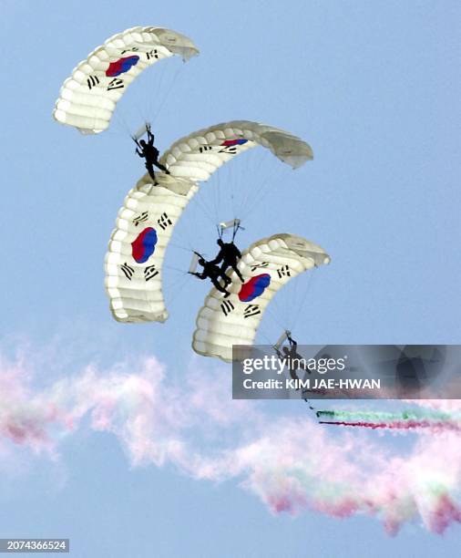 South Korean paratroopers display the South Korean flag on their parachutes during the 53rd Anniversary of South Korea armed forces day in Keryongdae...